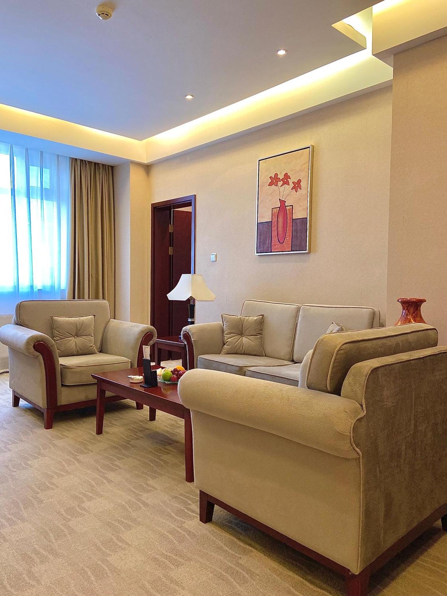 Beijing Palace Soluxe Hotel Astana Exterior photo A living room in a suite at the hotel