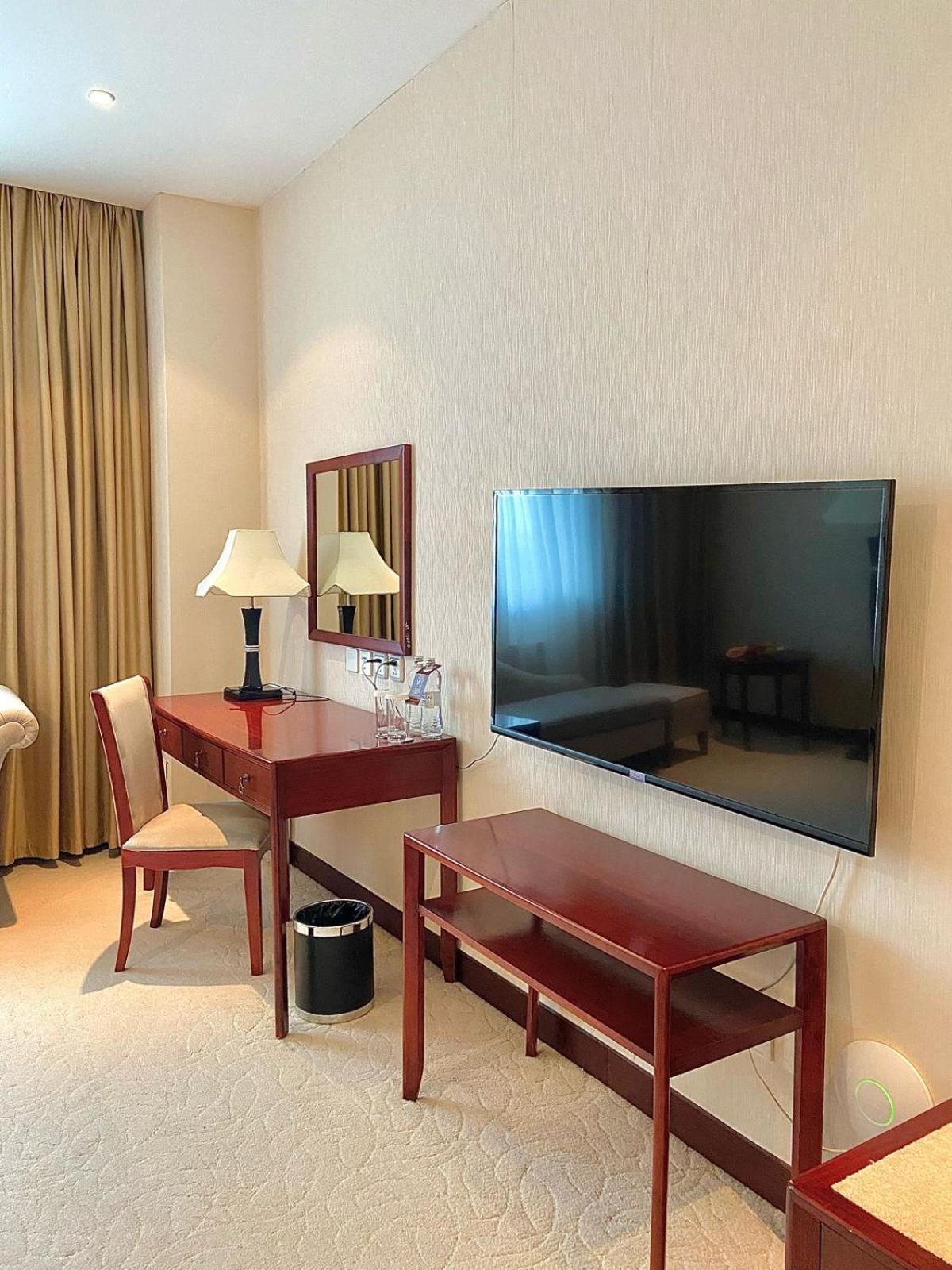 Beijing Palace Soluxe Hotel Astana Exterior photo A television set in a hotel room